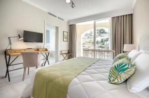 a bedroom with a bed and a desk with a computer at Cesca's Boutique Hotel in Xlendi +37 photos