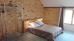 a bedroom with a bed and a shower at Au Tilleul in Archignac
