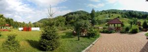 a garden with a gazebo and a hill at Svit Sontsya in Turʼya Polyana