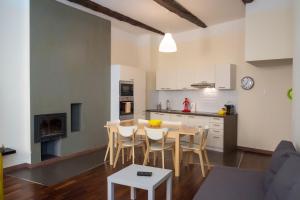 a kitchen and dining room with a table and chairs at Magnifiques Appartements au coeur du Vieux Nice in Nice
