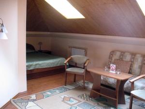 a room with a bed and a table and a chair at Kargopol Hotel in Kargopol'