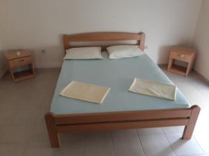 a bedroom with a bed with two night stands on it at Korac Apartments in Ulcinj