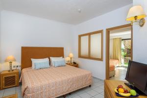 a hotel room with a bed and a television at Annabelle Beach Resort in Hersonissos