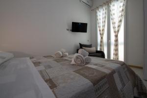 a bedroom with a large bed with towels on it at B&B ARCHIMEDE in Floridia
