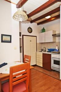 a kitchen with a table and chairs in a room at Apartment Maja in Dubrovnik