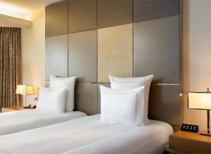
a hotel room with two beds and two lamps at Swissotel The Bosphorus Istanbul in Istanbul
