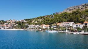 a group of boats in a body of water with houses at Apartman Anita in Jesenice