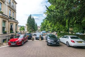 a group of cars parked in a parking lot at The Ayrlington Guesthouse in Bath