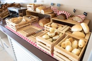 a bakery filled with lots of different types of bread at Yes Hotel Touring & SPA in Rimini