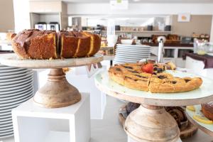a couple of cakes on two tiers in a bakery at Yes Hotel Touring & SPA in Rimini