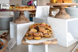 a display of muffins and pastries on a table at Yes Hotel Touring & SPA in Rimini