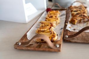 a plate of food on a cutting board with pretzels at Yes Hotel Touring & SPA in Rimini