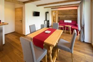a dining room with a wooden table and chairs at Das Hillside Maria Alm Hintermoos in Maria Alm am Steinernen Meer