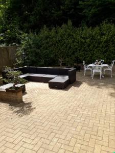 un patio con tavolo, divano, tavolo e sedie di The Grove, Grove Road Ryde Po333lh a Ryde