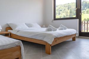 a bedroom with two beds and a large window at The FOXhouse in Tolmin