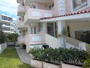 an apartment building with plants in front of it at Parthenis Riviera Hotel in Athens