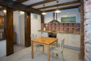 a kitchen with a wooden table and chairs at Dalmatian House in Split