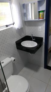 a bathroom with a sink and a toilet at Pousada Canto Nosso in São Pedro da Serra