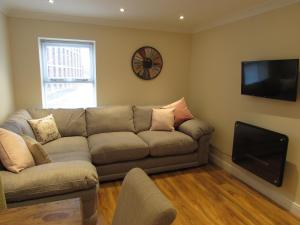 a living room with a couch and a flat screen tv at Apartment 2 in Darlington