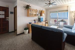 a living room with a couch and a kitchen at Bunda in Playa de Gandia