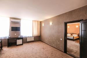 a large room with a bedroom and a bed at Evim Otel in Zaqatala
