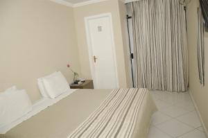 Ένα ή περισσότερα κρεβάτια σε δωμάτιο στο Serra Plaza Hotel