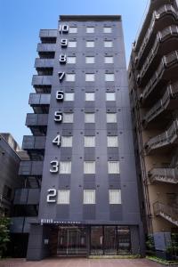 a building with the name of the hotel at Belken Hotel Kanda in Tokyo