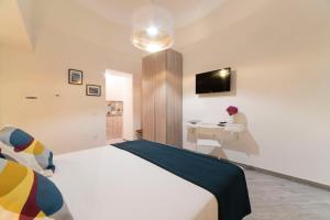 una camera con letto, scrivania e TV di Casa Taiani Amalfi Coast a Vietri
