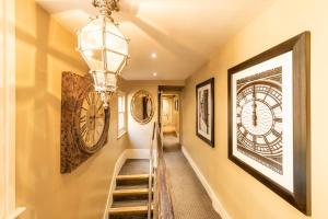 a hallway with a staircase and a clock on the wall at Fielding Hotel in London