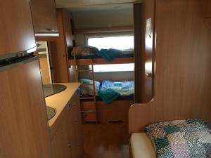 a small room with a kitchen and bunk beds at Caravans Bijela Uvala in Poreč