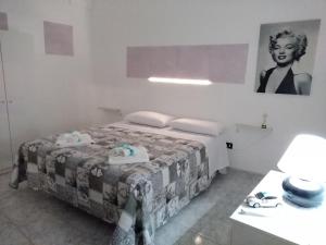 a bedroom with a bed and a table and a picture at Corte dei Giorgi in Vernole