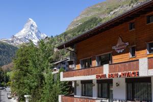 a building with a sign on the side of it at Hotel Beau Rivage in Zermatt