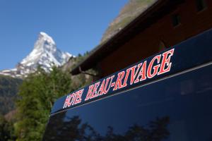 a snowboarder is looking out the window of a truck at Hotel Beau Rivage in Zermatt
