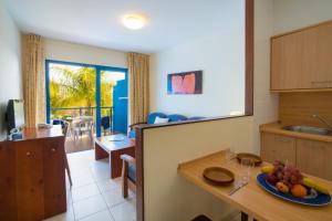 a kitchen with a table with a plate of fruit on it at Blue Sea Jandia Luz in Morro del Jable