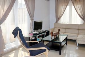 a living room with a couch and a table at NZHome Residence in Karawang