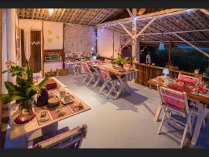 a large room with tables and chairs in it at Eco-Casa Bobô in Ilha de Boipeba