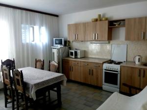 a kitchen with a table and a stove and a microwave at Villa Marija Ulcinj in Ulcinj