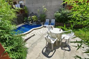 a patio with a table and chairs and a pool at Pejik apartment in Ohrid