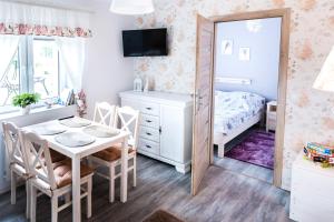 a small bedroom with a table and a mirror at Blisko Lasu in Ustrzyki Dolne