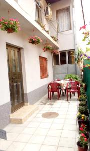 a patio with a table and chairs in front of a building at Hostel Olimpik in Negotin