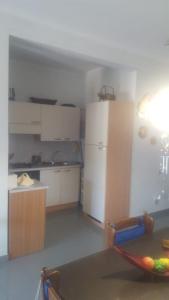 a kitchen with a refrigerator and a table in a room at appartamento Lory in Campomarino