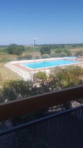 a view of a swimming pool from a balcony at appartamento Lory in Campomarino