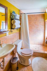 a bathroom with a toilet a sink and a bath tub at Pisac Inn in Pisac