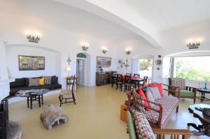 a living room with a couch and chairs and a table at Rallou House Hydra in Hydra