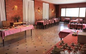 a restaurant with tables and chairs in a room at Santa Ana B&B in Darnius