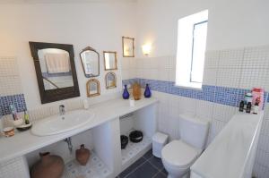 a bathroom with a sink and a toilet at Rallou House Hydra in Hydra +35 photos