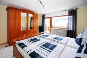 a bedroom with a bed with a dresser and a window at Im Kirchberg in Lieser