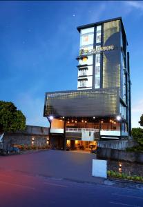 a large building with a lit up facade at night at Top Malioboro Hotel Jogja in Yogyakarta