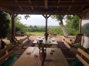 a patio with a table and chairs and a view at Guest House Mundzic- Sumski Mir in Irig
