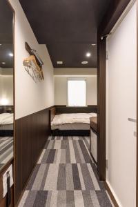 a master bedroom with a bed and a checkered floor at Belken Hotel Kanda in Tokyo +51 photos